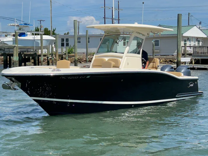  Yacht Photos Pics 2018 Scout 275 LXF boat on water, featuring sleek design and modern amenities.