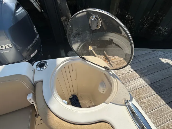  Yacht Photos Pics Open hatch on 2018 Scout 275 LXF boat, showing interior storage compartment.