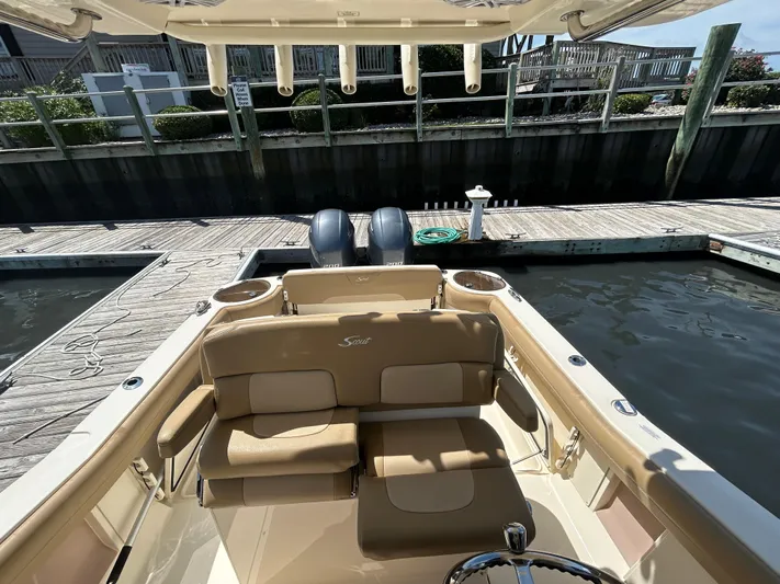  Yacht Photos Pics 2018 Scout 275 LXF boat docked, featuring tan seating and dual engines.