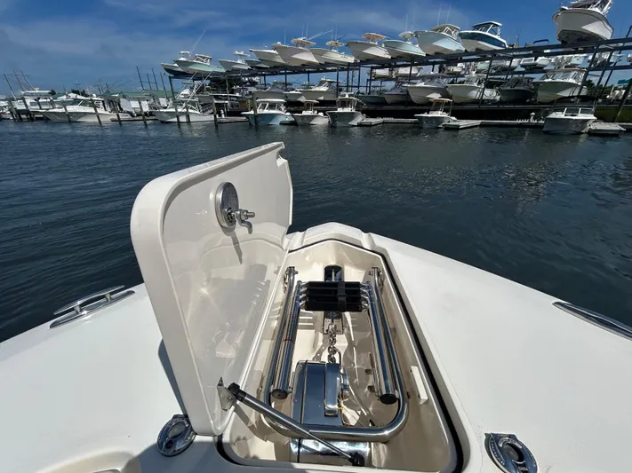  Yacht Photos Pics 2018 Scout 275 LXF boat with open anchor hatch, docked near stacked boats.