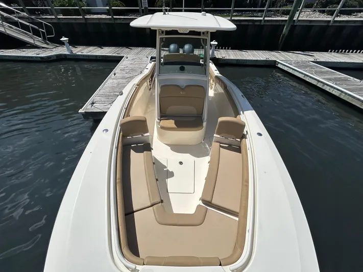  Yacht Photos Pics 2018 Scout 275 LXF boat docked, featuring spacious seating and sleek design.