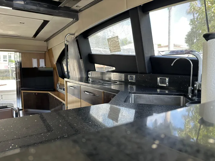  Yacht Photos Pics Luxurious interior of 2016 Sea Ray L590 yacht with modern kitchen amenities.