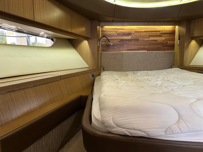  Yacht Photos Pics Luxurious 2016 Sea Ray L590 yacht bedroom with wood accents and cozy bedding.