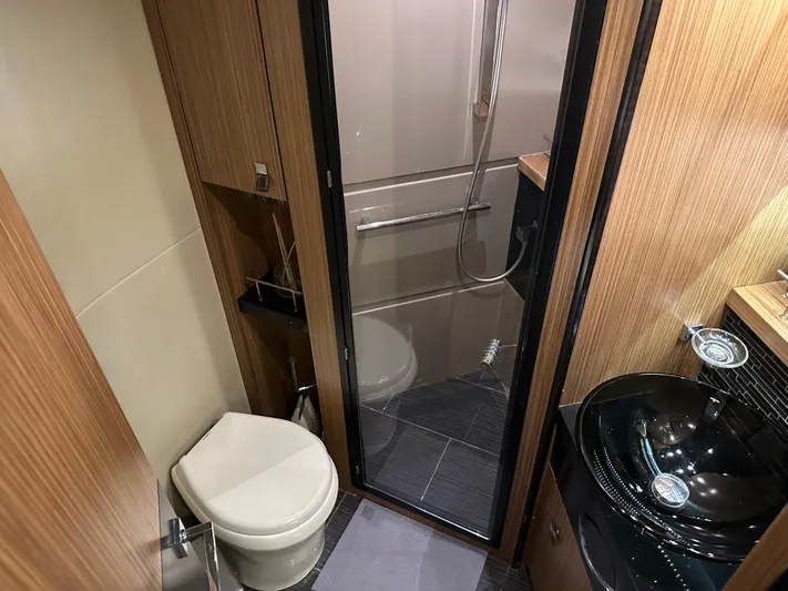  Yacht Photos Pics 2016 Sea Ray L590 yacht bathroom with modern fixtures and wood paneling.