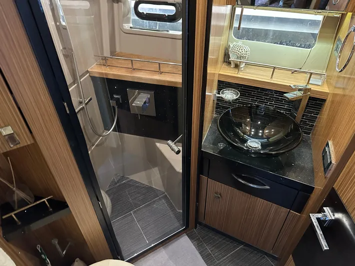  Yacht Photos Pics Luxurious bathroom in 2016 Sea Ray L590 yacht with modern fixtures and elegant design.