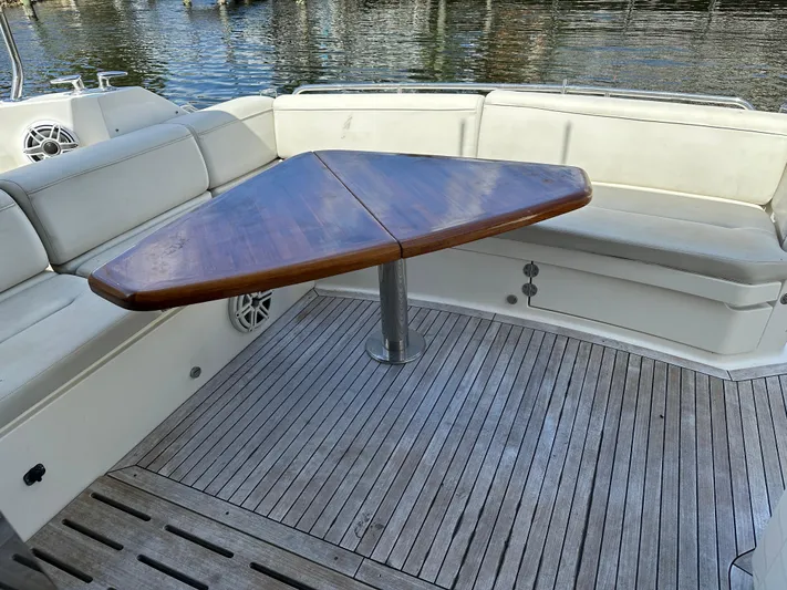  Yacht Photos Pics Luxurious 2016 Sea Ray L590 yacht with elegant wooden table and cushioned seating.