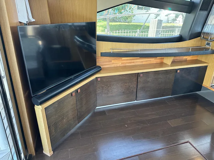  Yacht Photos Pics Interior of 2016 Sea Ray L590 yacht with TV and modern wood cabinetry.