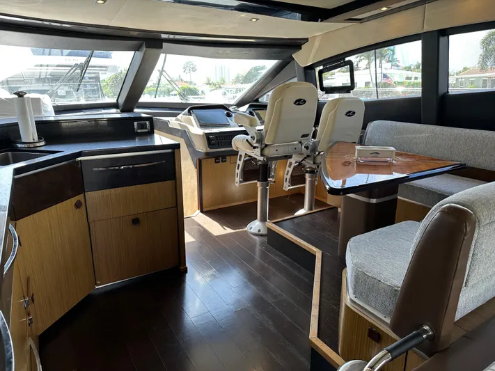  Yacht Photos Pics Luxurious 2016 Sea Ray L590 yacht interior with helm, seating, and modern kitchen area.