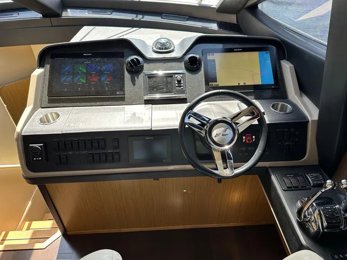  Yacht Photos Pics Helm of 2016 Sea Ray L590 yacht with modern navigation controls and steering wheel.