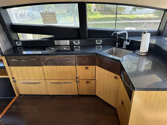  Yacht Photos Pics Luxurious kitchen interior of 2016 Sea Ray L590 yacht with modern appliances and sleek design.