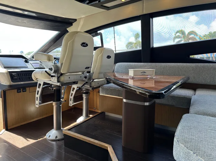  Yacht Photos Pics Luxurious interior of 2016 Sea Ray L590 yacht with helm chairs and elegant seating area.