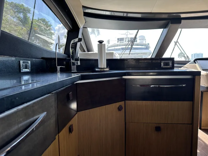  Yacht Photos Pics Luxurious interior of 2016 Sea Ray L590 yacht kitchen with modern fixtures and cabinetry.