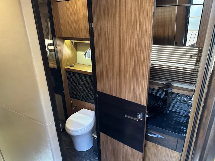  Yacht Photos Pics Luxurious bathroom interior of 2016 Sea Ray L590 yacht, featuring modern fixtures and wood accents.