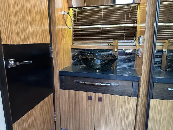  Yacht Photos Pics Luxurious bathroom interior of 2016 Sea Ray L590 yacht with modern sink and wood accents.
