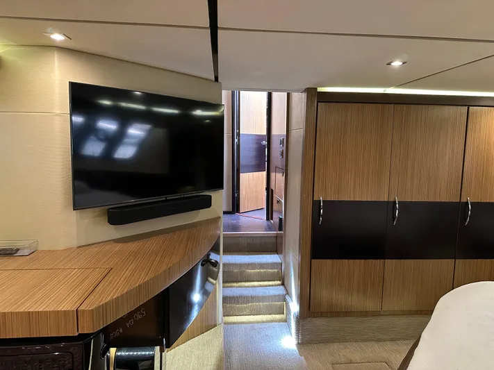  Yacht Photos Pics Luxurious interior of 2016 Sea Ray L590 yacht with modern TV and wooden cabinetry.
