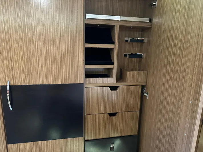  Yacht Photos Pics Wooden storage cabinet with shelves and drawers inside a 2016 Sea Ray L590 yacht.