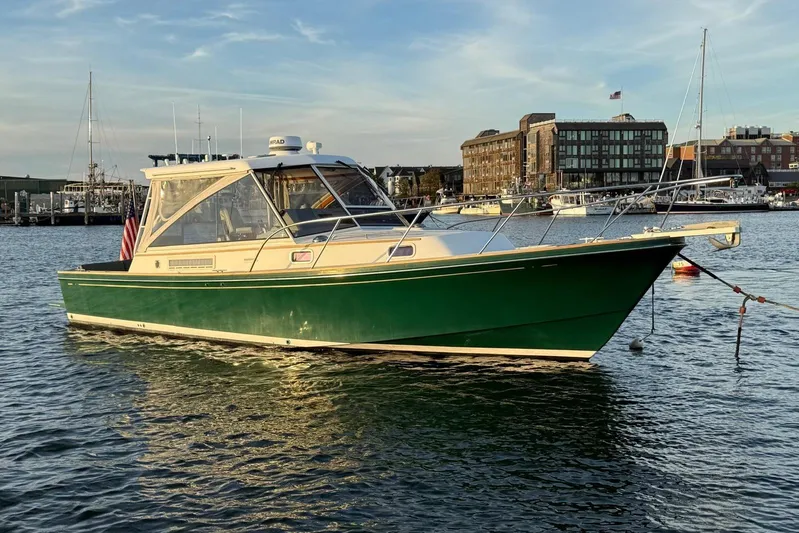 Lark Yacht Photos Pics 2000 Little Harbor Whisper Jet 34 boat on calm water, cityscape background.