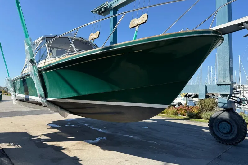 Lark Yacht Photos Pics 2000 Little Harbor Whisper Jet 34 boat lifted in marina, green hull, clear sky.