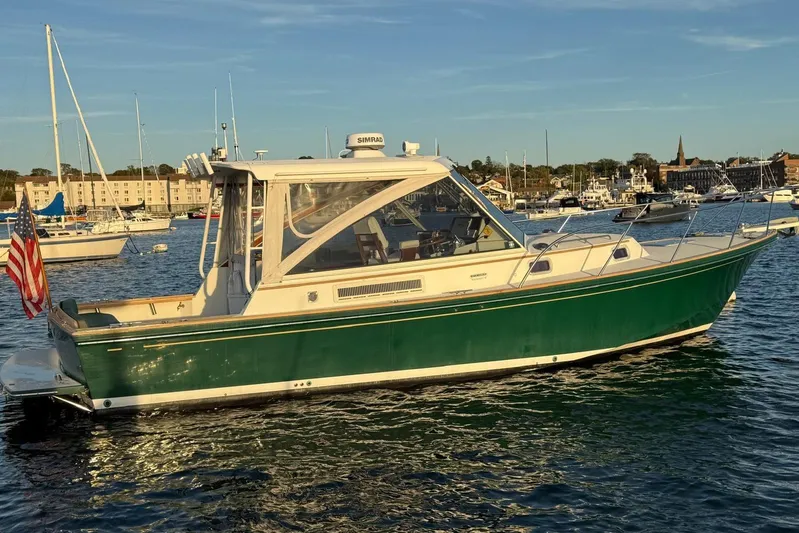 Lark Yacht Photos Pics 2000 Little Harbor Whisper Jet 34 boat on calm water, with American flag.