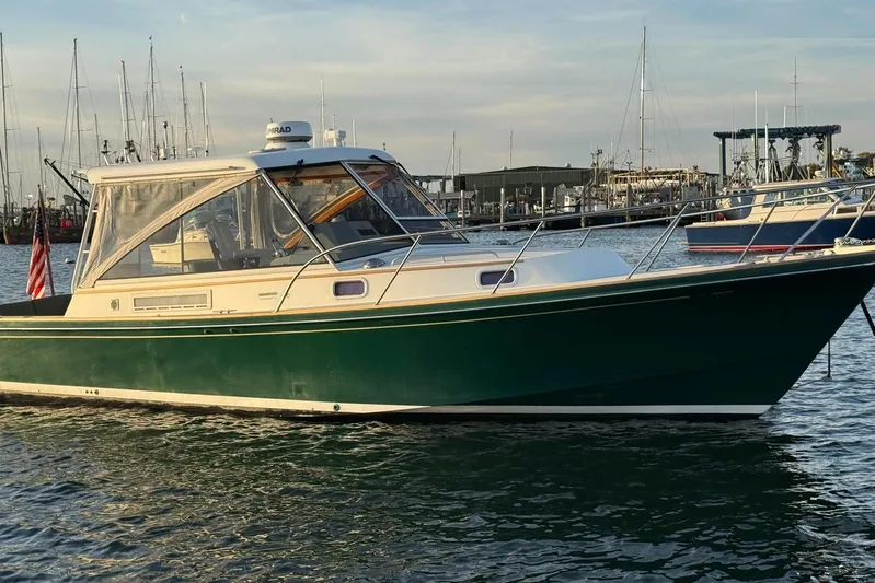 Lark Yacht Photos Pics 2000 Little Harbor Whisper Jet 34 boat docked in marina, green hull, clear sky.