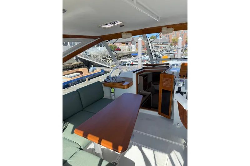 Lark Yacht Photos Pics Interior view of 2000 Little Harbor Whisper Jet 34, featuring seating and wooden table.