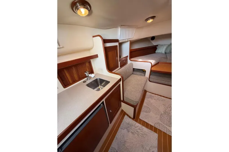 Lark Yacht Photos Pics Interior of 2000 Little Harbor Whisper Jet 34, featuring cozy seating and compact kitchenette.