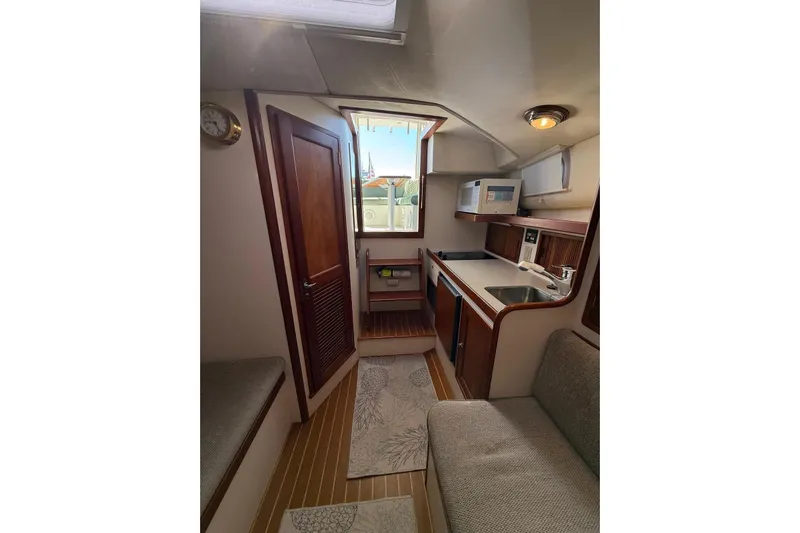 Lark Yacht Photos Pics Interior of 2000 Little Harbor Whisper Jet 34, featuring compact kitchen and seating area.
