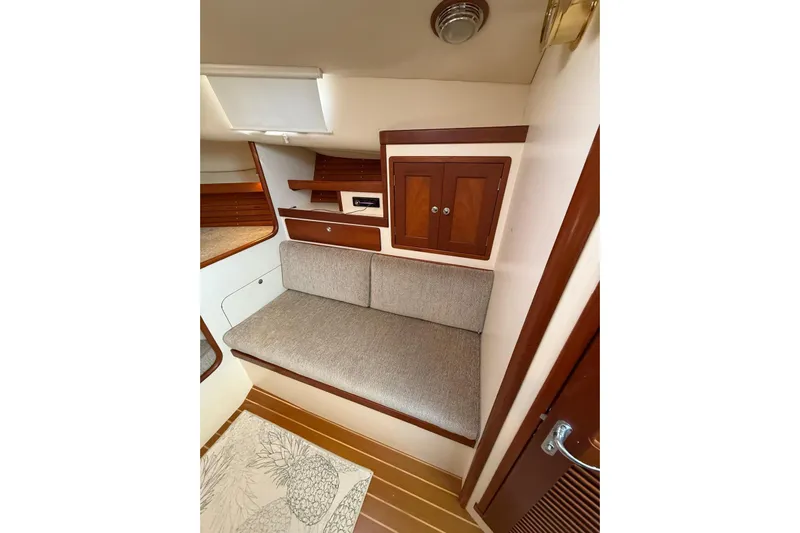 Lark Yacht Photos Pics Interior of 2000 Little Harbor Whisper Jet 34 with cushioned seating and wooden cabinetry.