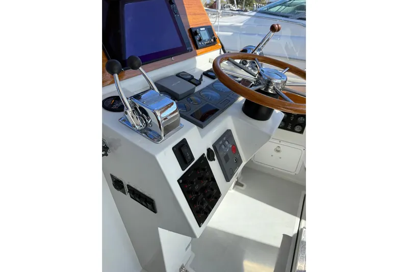 Lark Yacht Photos Pics Helm of 2000 Little Harbor Whisper Jet 34 with wooden steering wheel and controls.