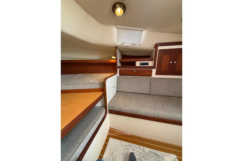 Lark Yacht Photos Pics Interior of 2000 Little Harbor Whisper Jet 34, featuring cozy seating and wooden cabinetry.