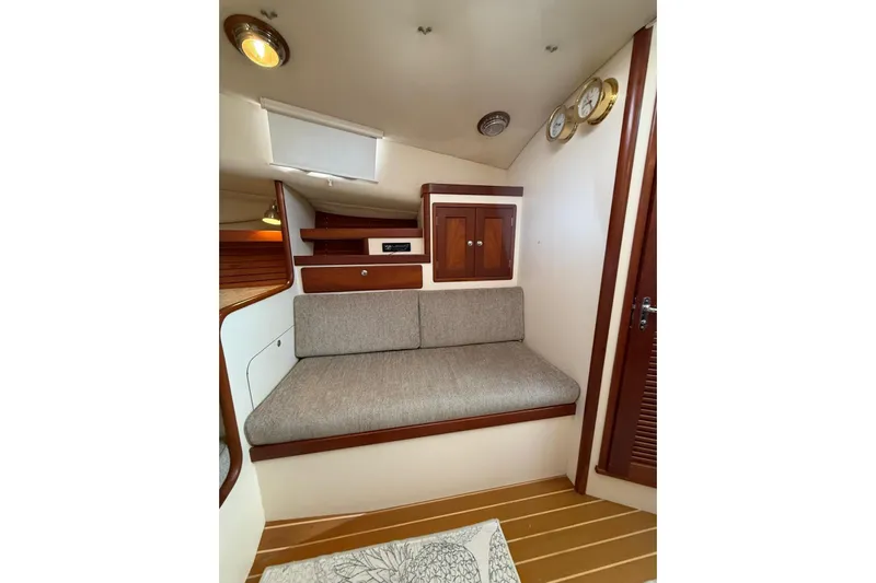 Lark Yacht Photos Pics Interior of 2000 Little Harbor Whisper Jet 34, featuring cozy seating and wooden cabinetry.
