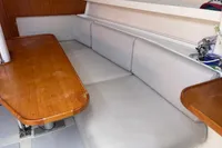 Interior of a 2003 Solaris 36 yacht with wooden table and cushioned seating.