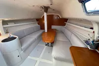 Interior of a 2003 Solaris 36 sailboat with seating and wooden table.