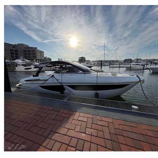  Yacht Photos Pics 2025 FIM 440 Regina yacht docked at marina under a bright sunlit sky.