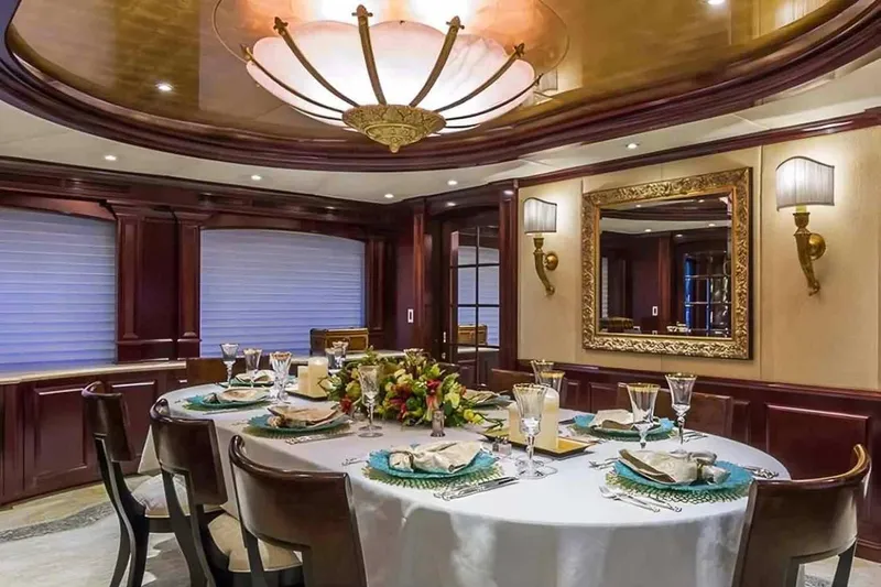 True Love Yacht Photos Pics Luxurious dining area on a 2003 Trinity Yachts motoryacht, featuring elegant decor and table setting.