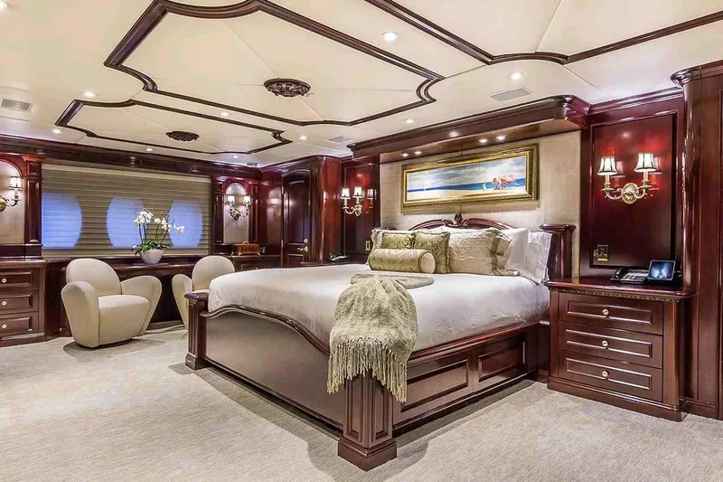 True Love Yacht Photos Pics Luxurious bedroom interior on 2003 Trinity Yachts Motoryacht with elegant wood finishes.