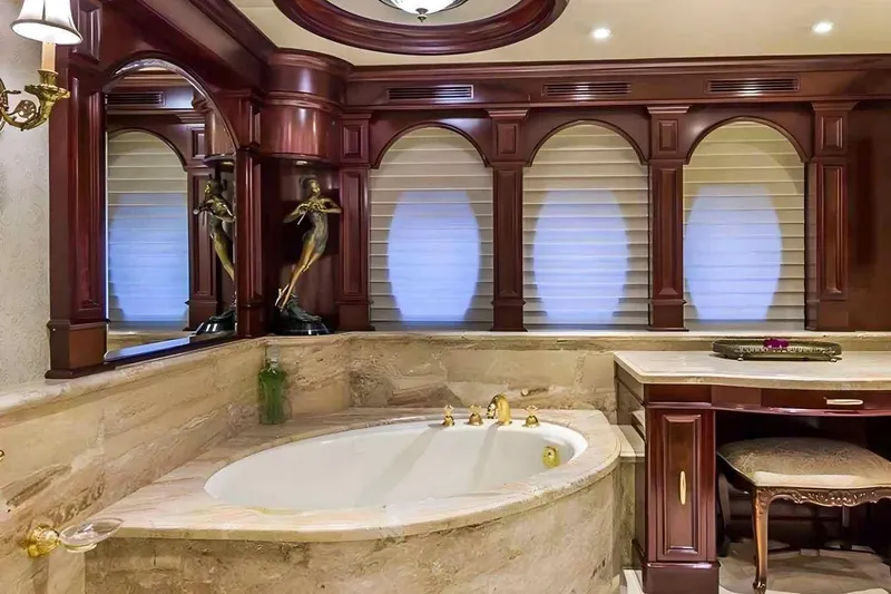 True Love Yacht Photos Pics Luxurious bathroom interior on 2003 Trinity Yachts Motoryacht with elegant wood accents and marble finishes.