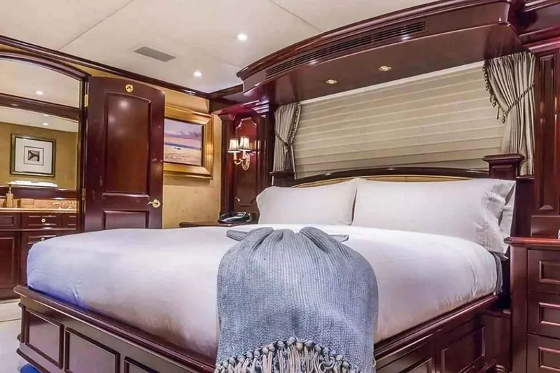 True Love Yacht Photos Pics Luxurious bedroom interior on 2003 Trinity Yachts motoryacht with elegant wood finishes.