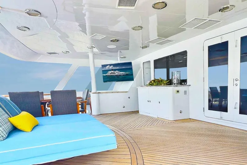 True Love Yacht Photos Pics Luxurious 2003 Trinity Yachts motoryacht deck with seating, TV, and ocean view.