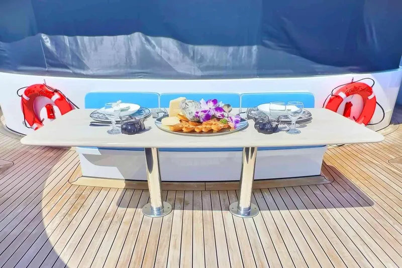 True Love Yacht Photos Pics Luxurious dining setup on 2003 Trinity Yachts motoryacht deck with elegant tableware.