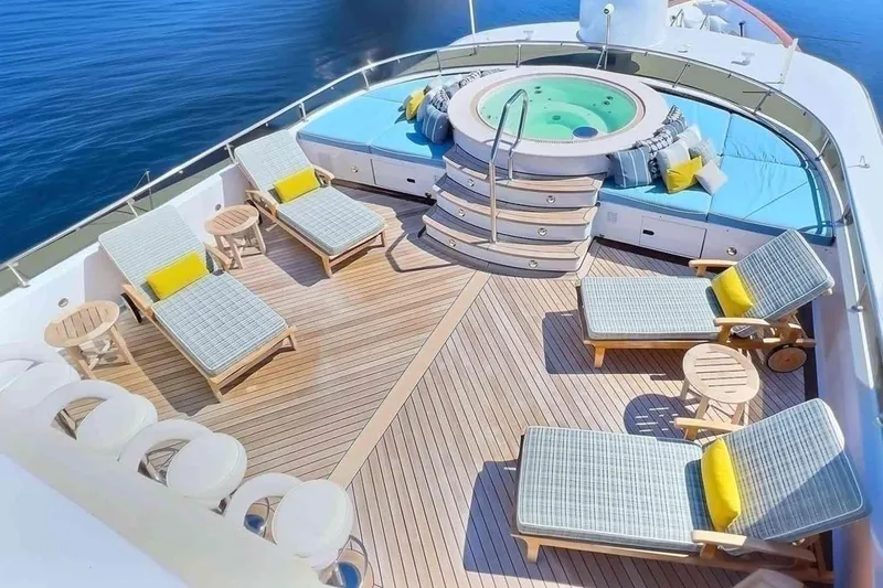 True Love Yacht Photos Pics Luxurious 2003 Trinity Yachts motoryacht deck with jacuzzi, sun loungers, and ocean view.