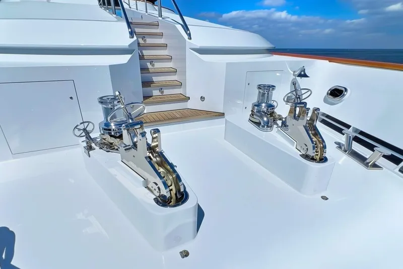 True Love Yacht Photos Pics Deck of 2003 Trinity Yachts Motoryacht with winches and stairs under blue sky.