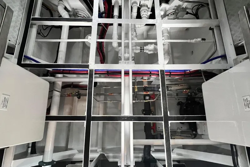 True Love Yacht Photos Pics Engine room of 2003 Trinity Yachts Motoryacht, showcasing intricate piping and wiring systems.