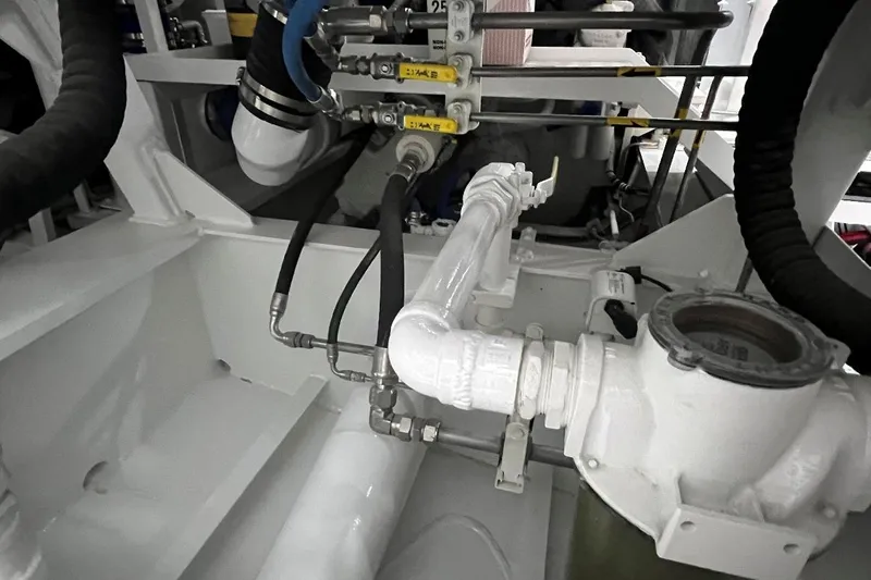 True Love Yacht Photos Pics Engine room of 2003 Trinity Yachts Motoryacht, showcasing pipes and mechanical components.