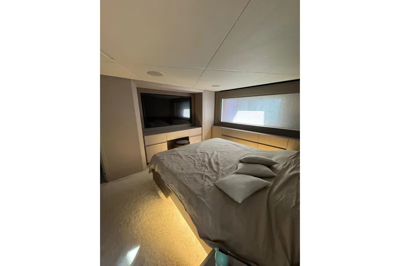  Yacht Photos Pics Luxurious bedroom interior of 2021 Pershing 7X yacht with modern design and ambient lighting.