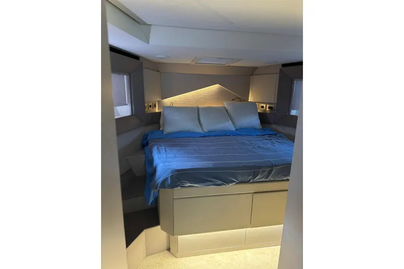  Yacht Photos Pics Luxurious bedroom interior of 2021 Pershing 7X yacht with modern design and cozy bedding.