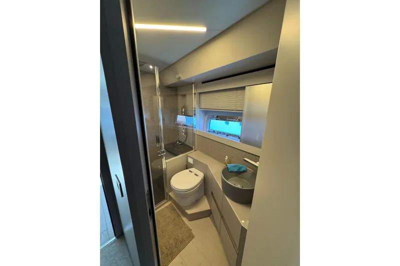  Yacht Photos Pics Luxurious bathroom in 2021 Pershing 7X yacht with modern fixtures and sleek design.