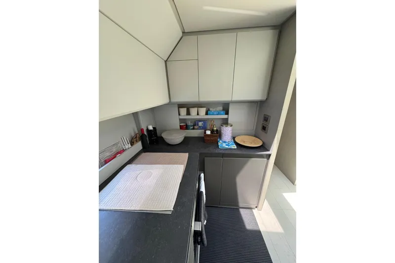  Yacht Photos Pics Modern kitchen interior on 2021 Pershing 7X yacht, featuring sleek cabinetry and countertops.