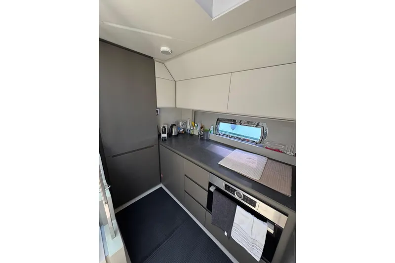  Yacht Photos Pics Modern kitchen interior of 2021 Pershing 7X yacht with sleek cabinetry and appliances.