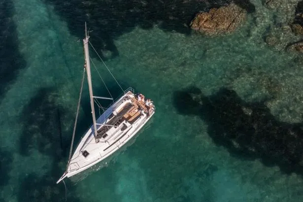C'est Chic Yacht Photos Pics Manufacturer Provided Image: Aerial view of 2025 Jeanneau Sun Odyssey 350 sailing in clear turquoise waters.